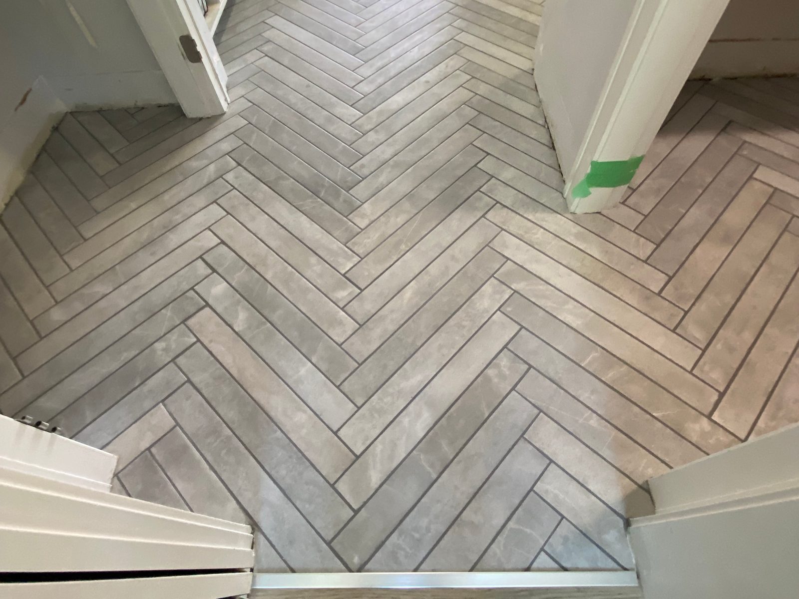Herringbone Tile Floor by Aymont Drywall